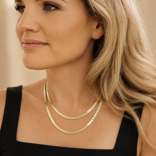 Model wearing The Sandra Pack layered gold herringbone necklaces